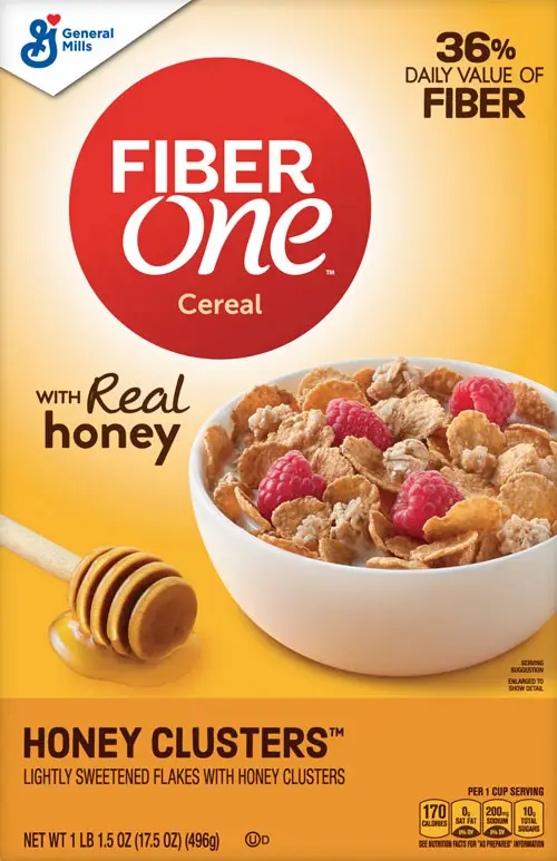 Cereal bowl with raspberries and honey dipper.