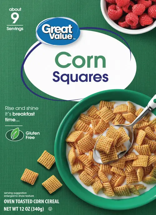 Bowl of corn cereal with spoon and raspberries.