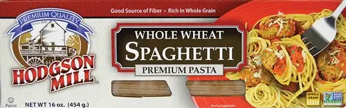 Whole wheat spaghetti package with fork holding pasta.